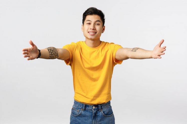 Come here let me hug you. Tender and touched charming lovely asian guy with tattoos, welcoming