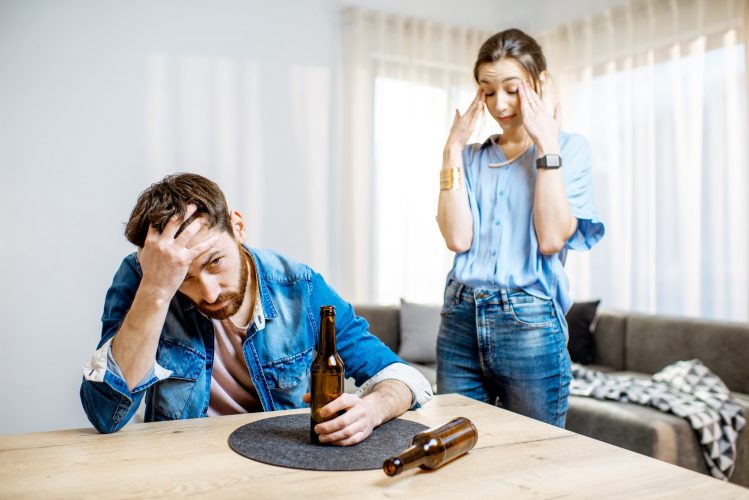Drunk man with woman at home