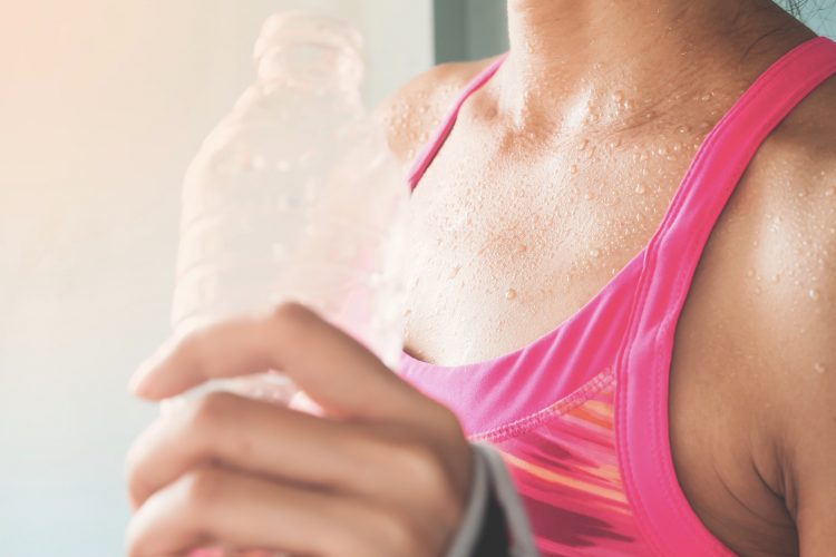 Focus on woman's body with sweat on tanning skin, Healthy lifestyle