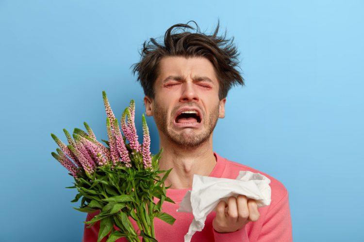 Miserable man in depression suffers from allergic malaise and rhinitis, seasonal disease, tired of s