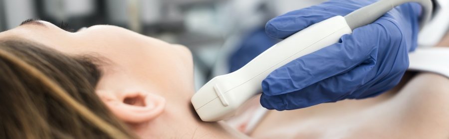 panoramic shot of doctor examining thyroid of female patient with ultrasound scan in clinic