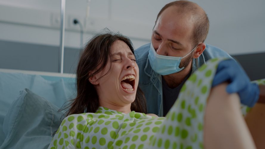 Pregnant young woman giving birth to child feeling tired