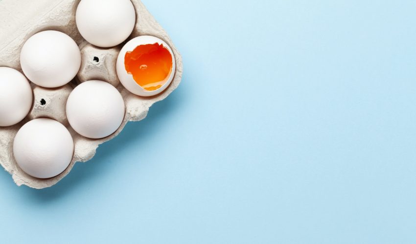 Six egg pack on blue background