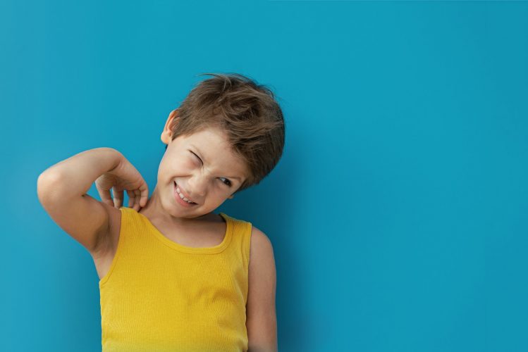 The boy scratches his skin, insect bite. Laziness. Copy space