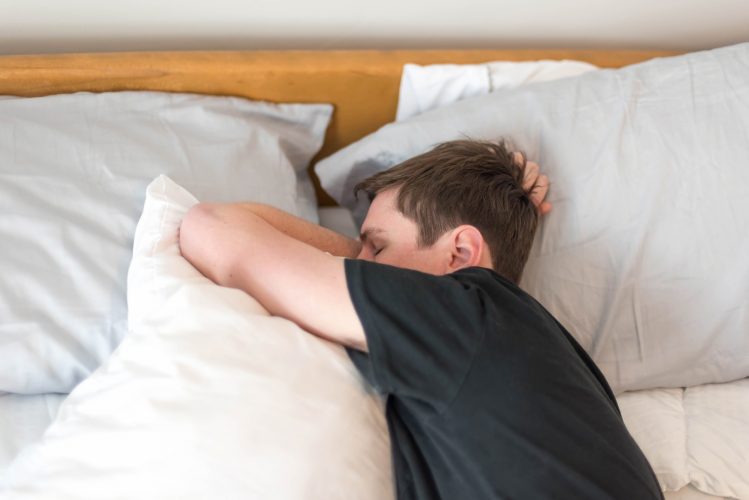Young man sleeping on his side