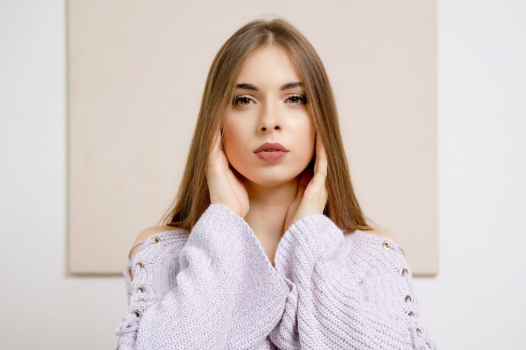Young woman touching ears