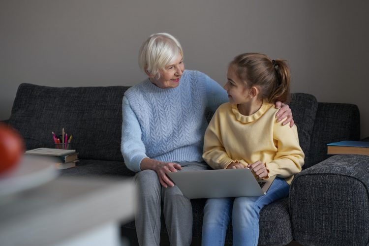 Adorable child making eye contact with her lovely grandma
