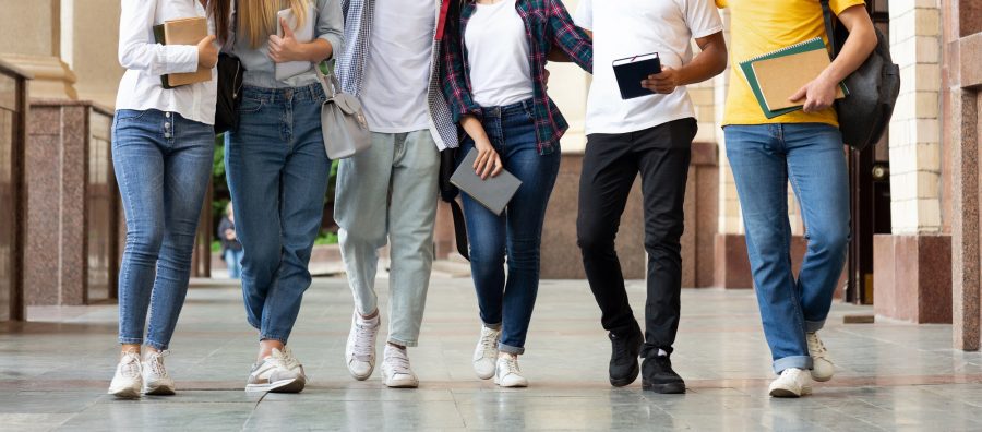College classmates walking after classes outdoors, crop