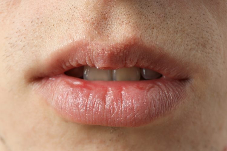Concept of body care with mouth of young man