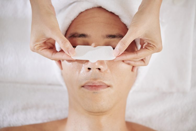 Cosmetologist applying nose strip