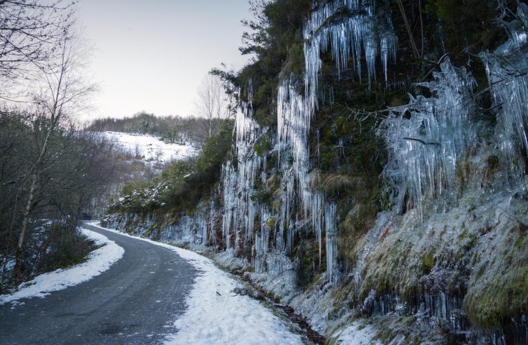 Dangerous winter conditions on a road after a freezing night