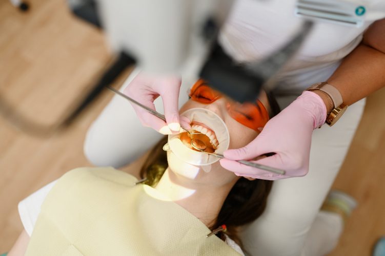 Female dentist and patient with opened mouth
