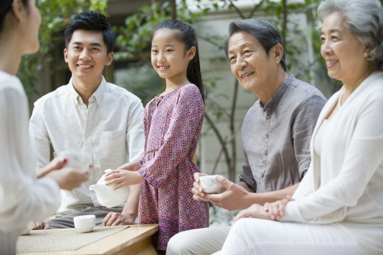 Happy family drinking tea together