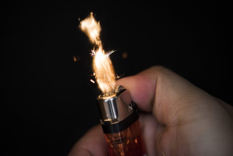 Macro shot of hand holding lighter
