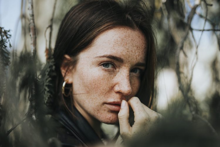 Portrait of a young woman with freckles