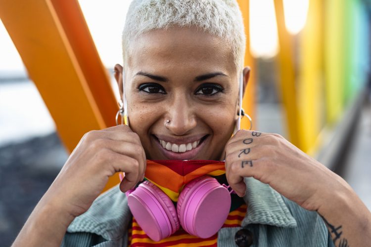 Portrait of young woman wearing gay pride mask symbol of LGBTQ social community