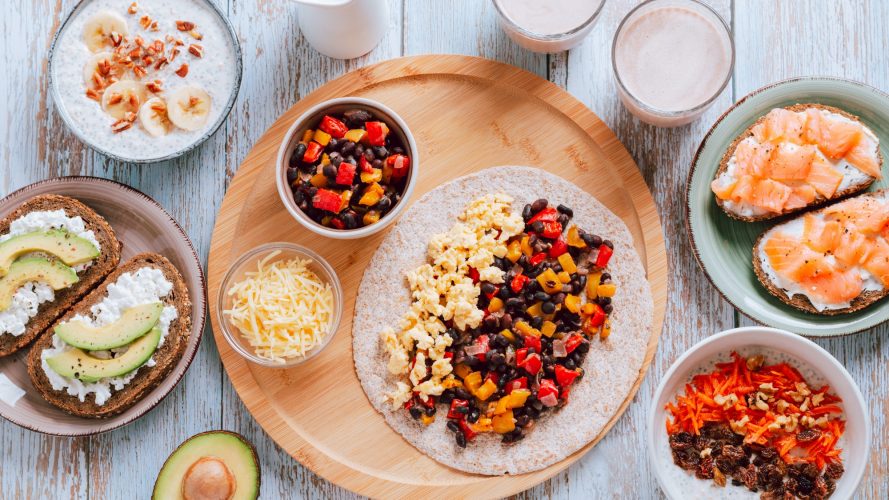 Set table with high protein breakfast dishes, top view