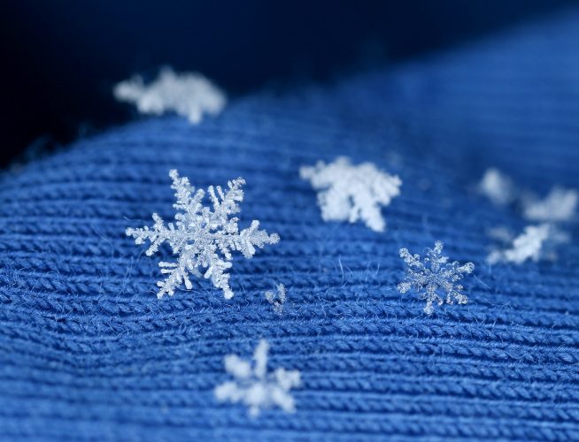 Snow flake crystals on blue knitten wool