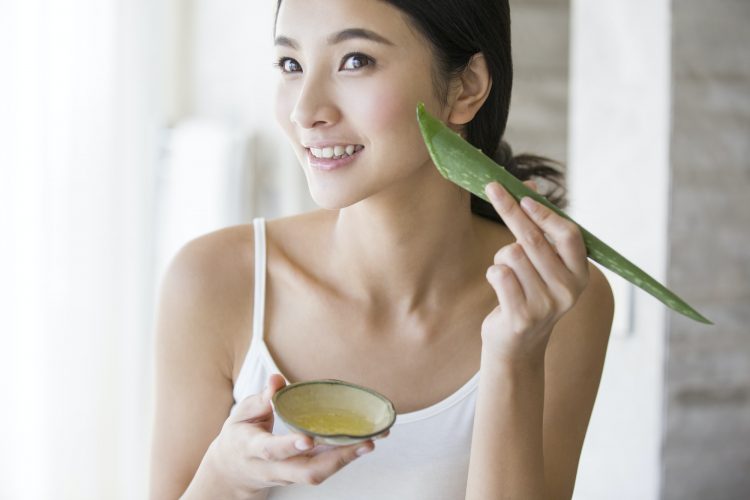 Young woman with natural aloe vera