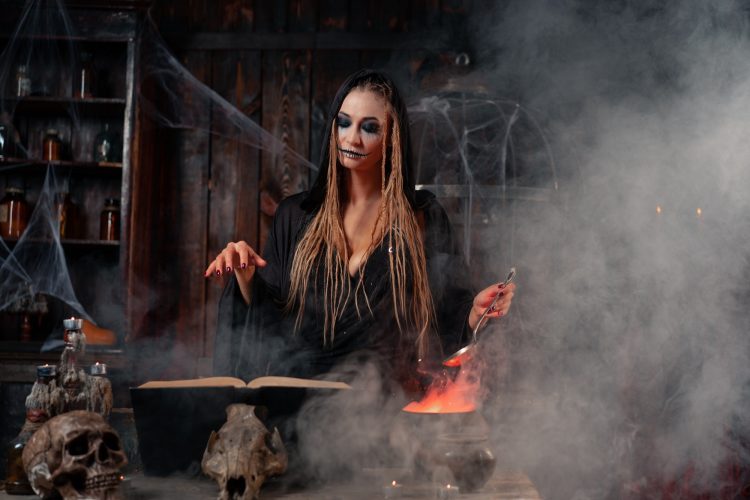 Halloween, witch use magic book and cauldron prepare poison or love potion