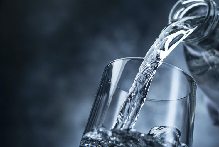 Pouring water on black background
