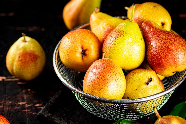 Ripe pears in a colander.