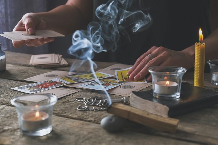 Tarot cards, Fortune telling on tarot cards at night by candlelight, magic crystal, occultism