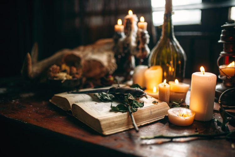 Witchcraft, dark magic, candles with ritual book