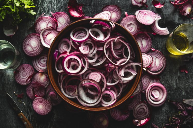 close up of sliced red onion, intended as a background image