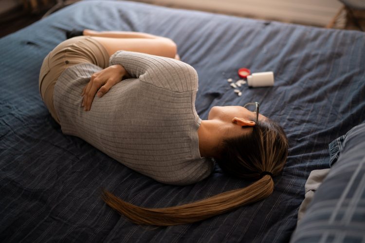 Young White Woman Suffering With Extreme Abdominal Menstrual Pain Cramps