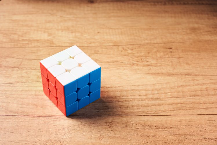 Dobrush, Belarus - 3 February 2019. Rubics cube on a wooden background, top view