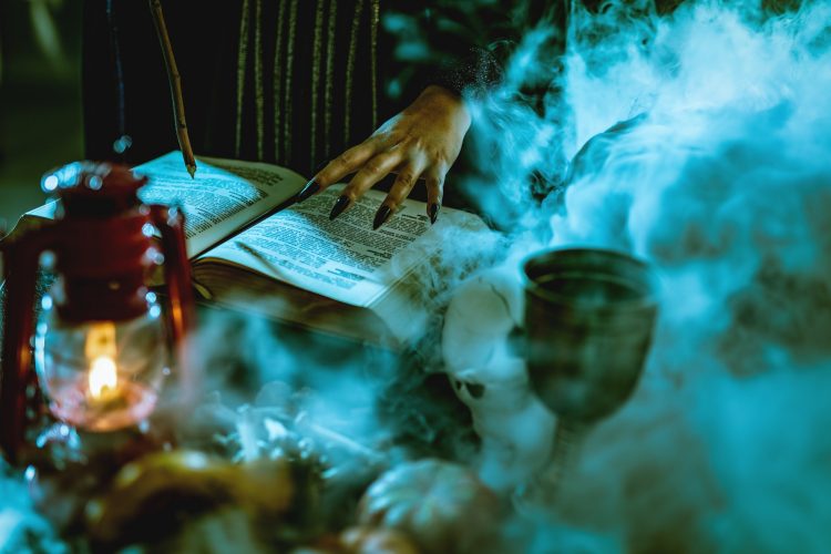 Witch's Hand On Magic Book