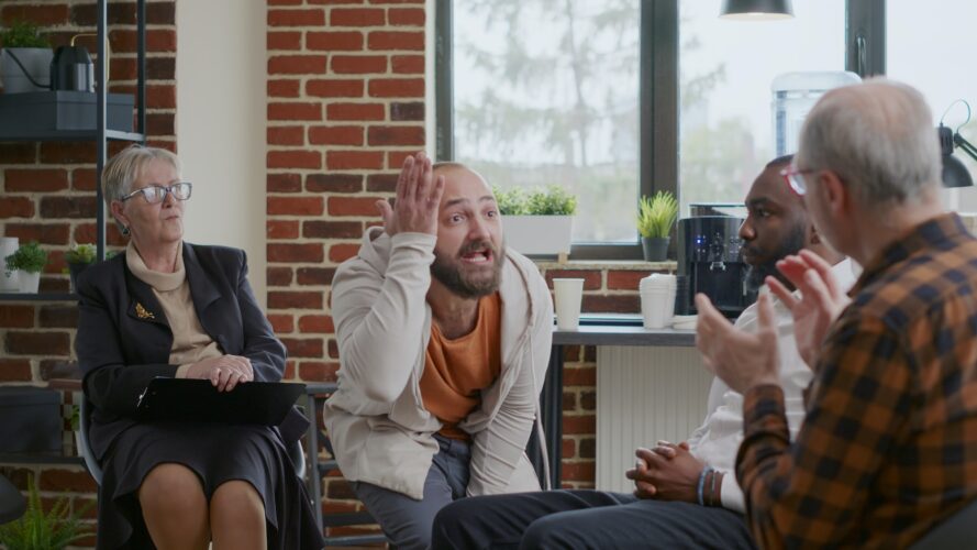 Alcohol addict with desperate behavior having breakdown at aa therapy meeting