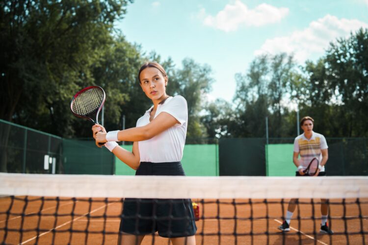 Young couple playing tennis