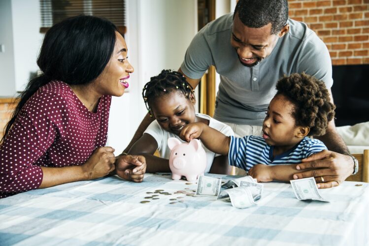 Family saving money in piggy bank