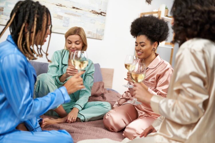 Smiling african american woman holding glass of wine