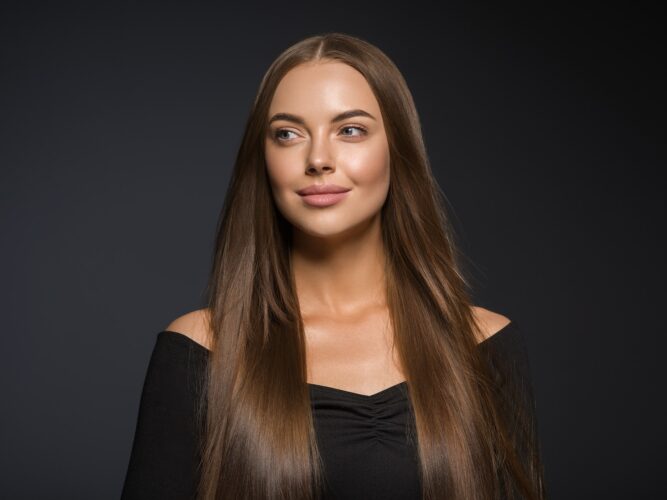 Smooth beauty woman long hair brunette female model natural makeup beautiful girl dark background