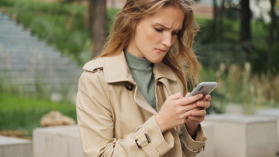 Student girl biting lip looking worry while texting with classma