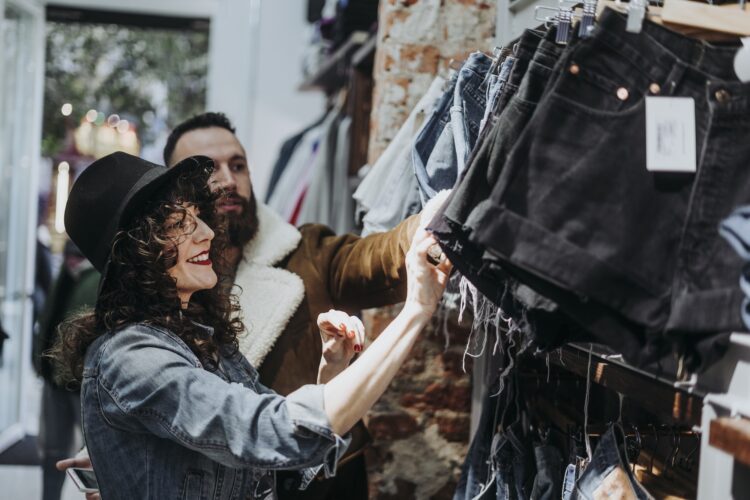 Woman buying clothes at the fashion store with boyfriend