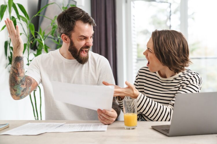 Young white couple working together with laptop
