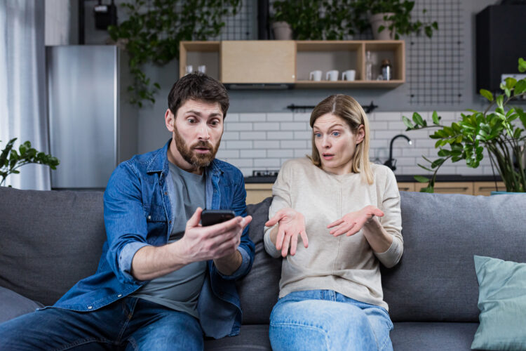 Family conflict at home. An angry man suspects a woman of treason, shouts at her, demands