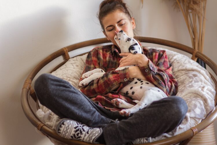 Girl kissing dalmatian dog