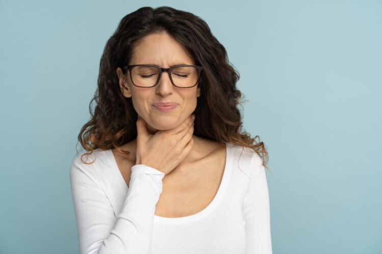 Sick woman having sore throat, tonsillitis, feeling sick, suffering from painful swallowing isolated