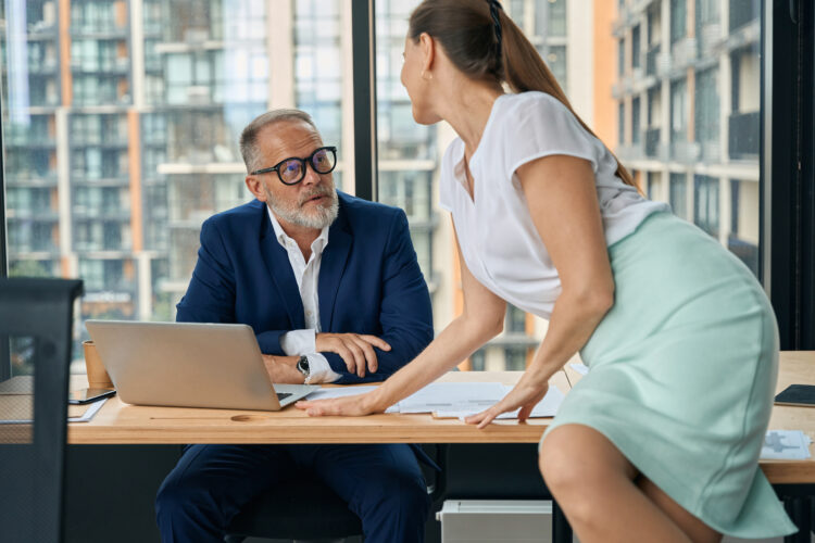 Woman flirting with male boss in office during working day