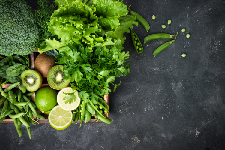 Green vegetables background. Fresh garden produce. Broccoli, spinach, kiwi, lettuce