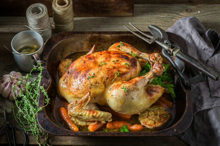 Grilled chicken with thyme and carrots. Roasted chicken with herbs.