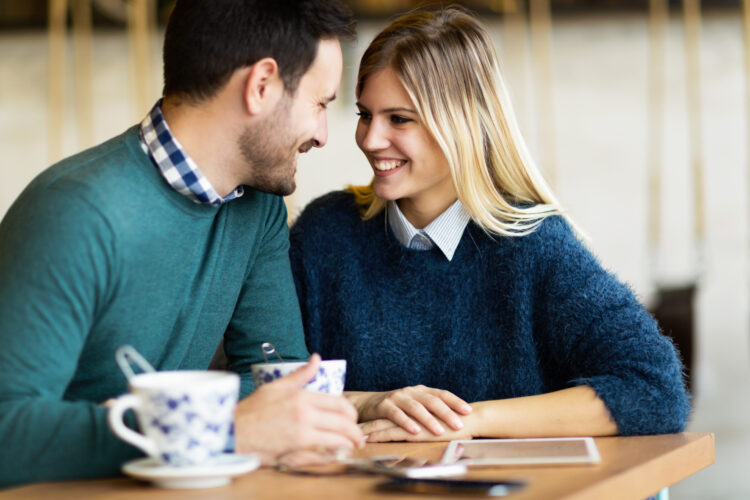 Happy young couple on date in coffee shop