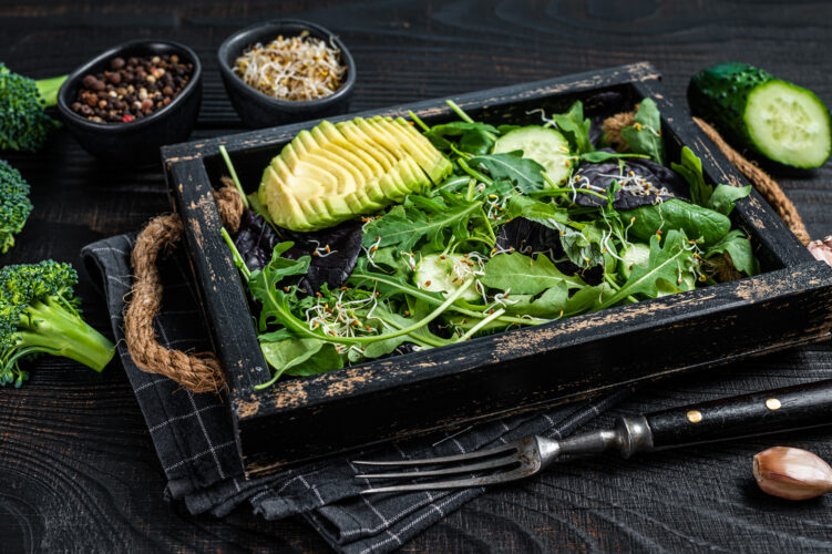 Vegetarian green salad with salad leaves mix, avocado and vegetables.