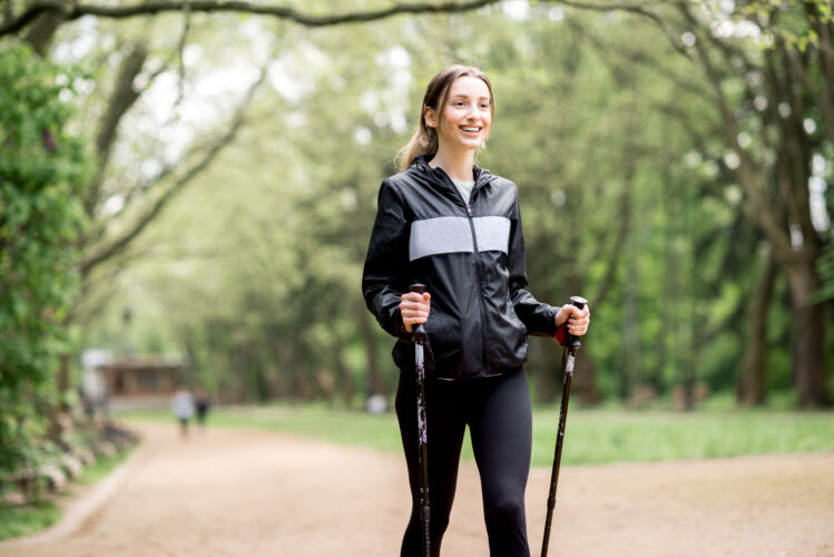 Woman walking with hiking sticks