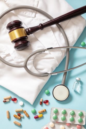 Health and Medicine legal issues. Judge gavel, medical stethoscope and medication